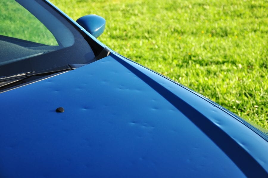 Carolina Collision and Frame Service | Blue car with hail damage on its hood